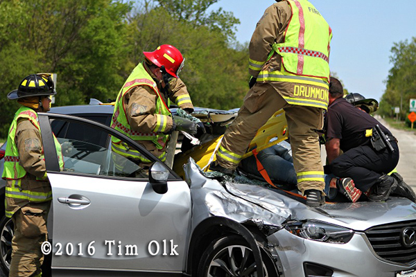 firefighters extricate motorcycle rider from car windshield
