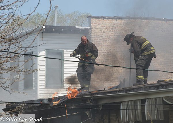 Chicago firefighters overhaul after house fire