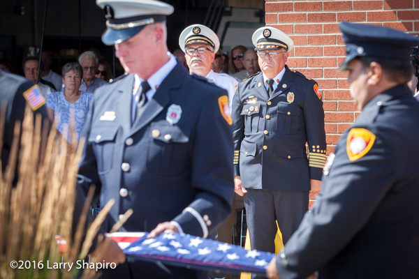 fire department honor guard folds American flag