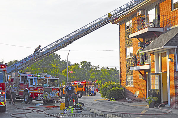aerial ladder truck to apartment building roof after fire
