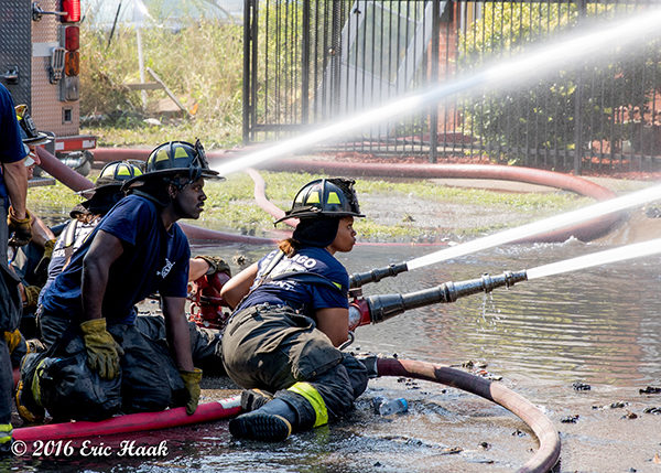African American firefighters with hose line