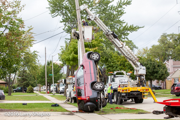 car stuck on utility pole support cables