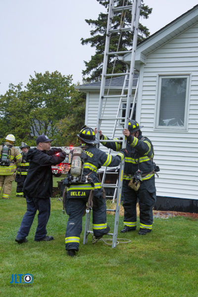 firefighters raise ground ladder