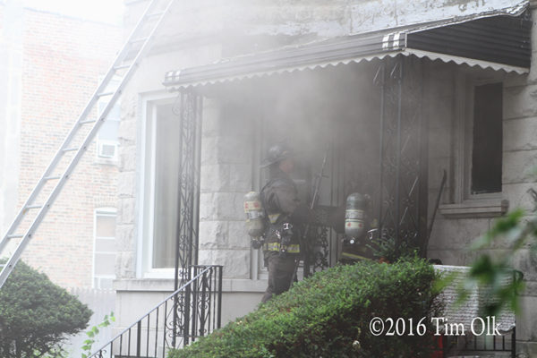 firefighters making entry through smoke