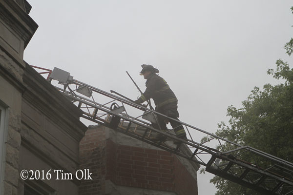 firefighter climbs aerial ladder