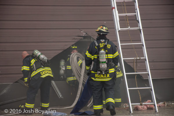 firefighters cut through overhead door