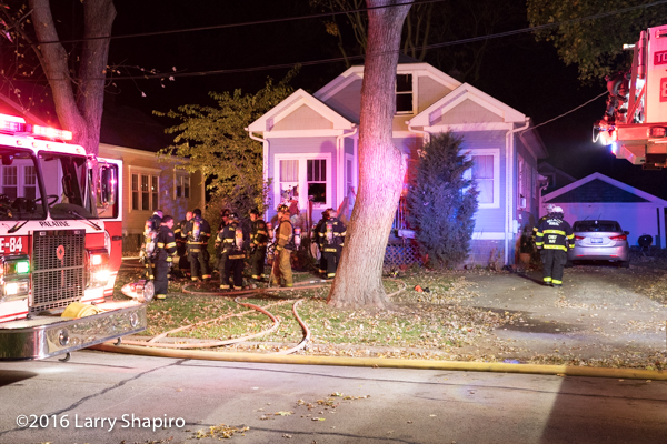 Firefighters outside house after battling a fire