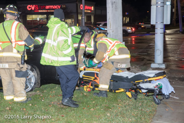 Firefighter/paramedics load crash victim onto a Stryker cot
