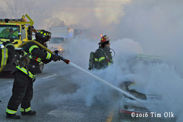 Firefighters at a car fire on the expressway