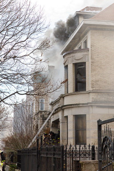 smoke billows from large home
