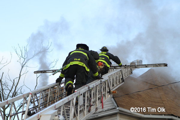 Firefighters climbing aerial ladder