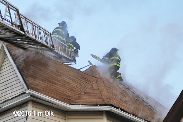 Firefighter venting a house roof