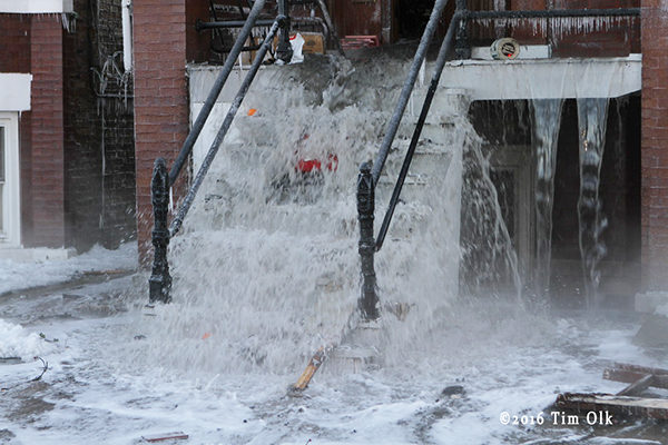 water gushes from fire building