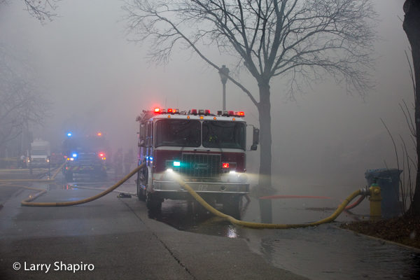 fire engine enveloped in smoke at fire scene
