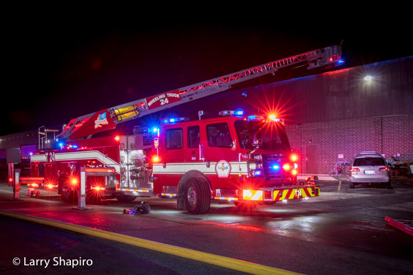 Rosenbauer America Commander Cobra tower ladder at night fire scene with lights