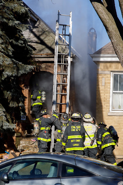 firefighters work at a house fire