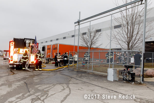 firefighters standby at warehouse fire
