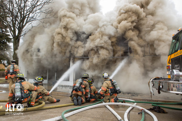firefighters in street battle fire with which smoke