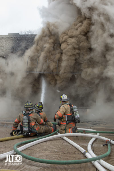 firefighters in street battle fire with which smoke