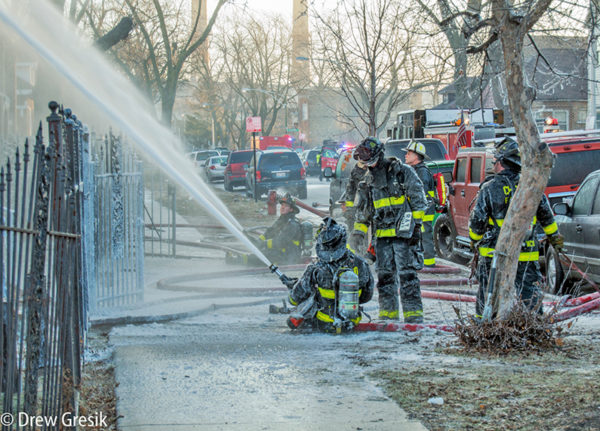firefighters covered with ice battling fire