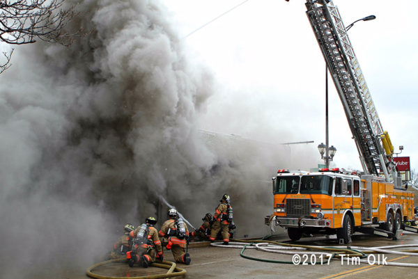 heavy smoke pushes from commercial building fire