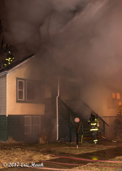 Firefighters battle house fire at night