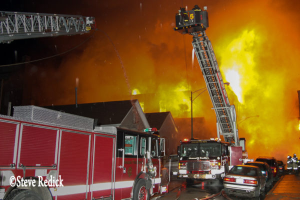 massive fire burns in warehouse at night