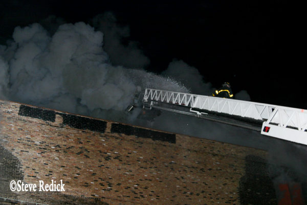 heavy smoke from warehouse fire at night