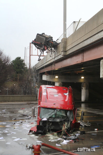 semi chassis dangling over a street where the cab separated 