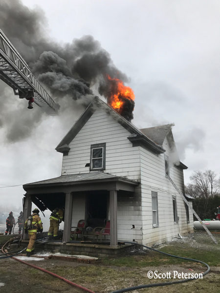 flames through roof of house