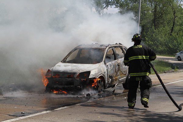 firefighters extinguish a car fire