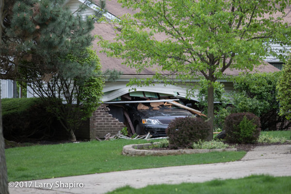 elderly driver crashes car through garage of a house