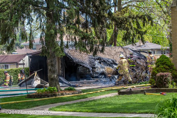 Firefighters at the scene of a detached garage that was destroyed by fire