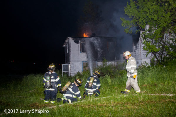 firefighters battle fire in a vacant house