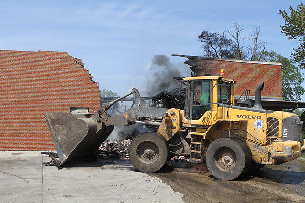 end loader clearing debris after a fire