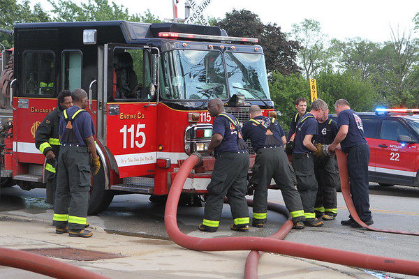 firefighters break down hose after a fire