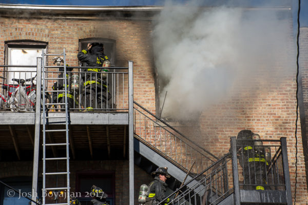 firefighters on rear porches with fire