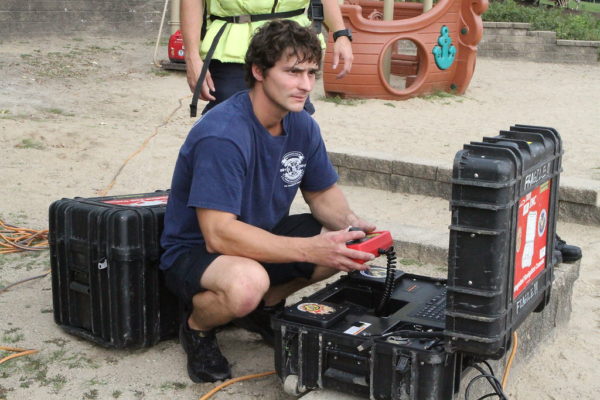 firefighter monitors sonar at dive recovery