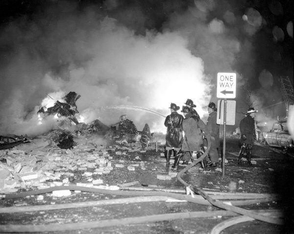 Firefighters work at an airplane crash site 11-24-59 in Chicago