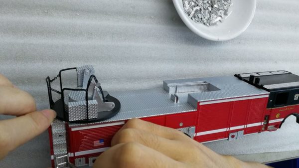 assembling a scale model of a Chicago fire truck