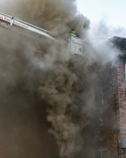 Chicago firefighters immersed in smoke at fire scene
