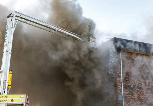 Chicago firefighters immersed in smoke at fire scene