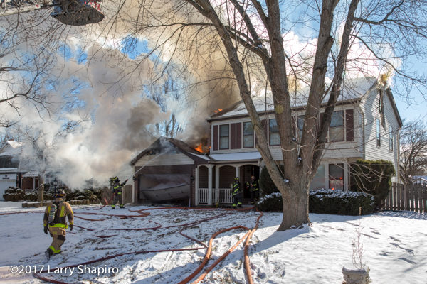 smoke and flames from house fire in the winter