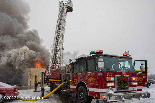 Pierce tower ladder battles commercial building fire