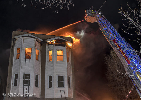 E-ONE tower ladder battles fire at night