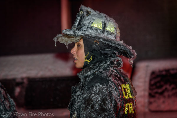 female firefighter covered with ice
