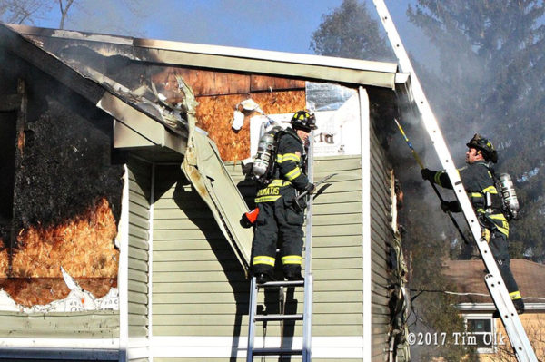 firefighters overhaul house fire in Lisle IL
