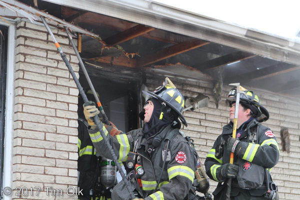 firefighters overhaul after house fire