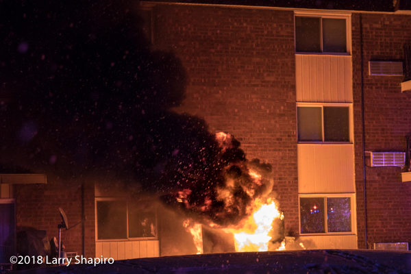 electric utility box engulfed in flames outside apartment building
