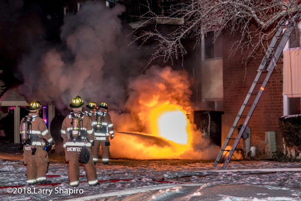 firefighters attack electric fire with extinguisher